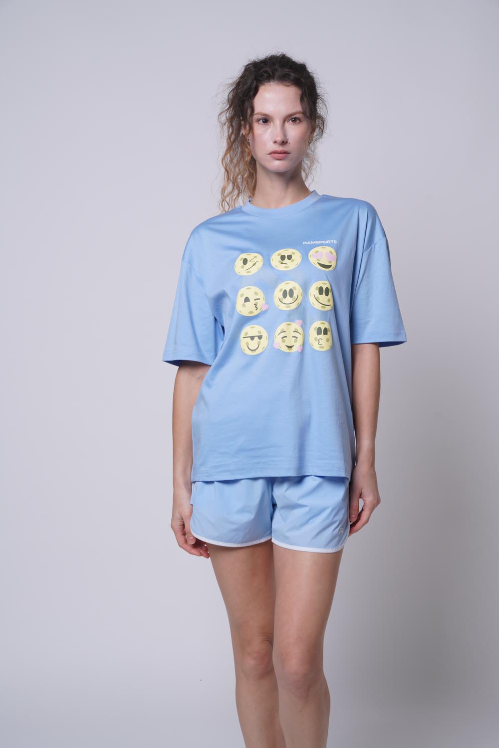 female model wearing Ramsports Court Moods Icon Grid T-shirt in blue