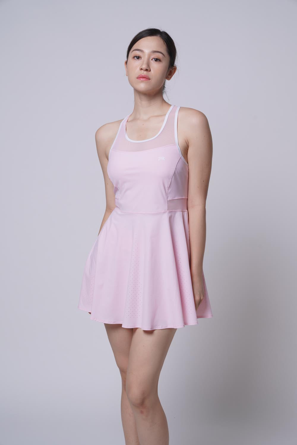 asian female model standing as she's Ramsports Racer Flare Dress in pink