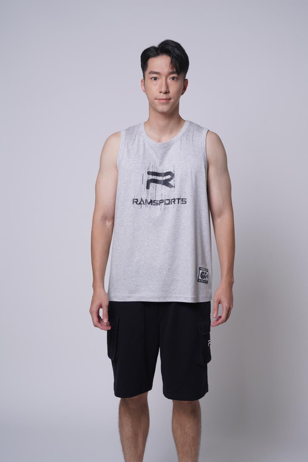 Asian male model posing with a straight body, wearing Ramsports repMark tank in gray