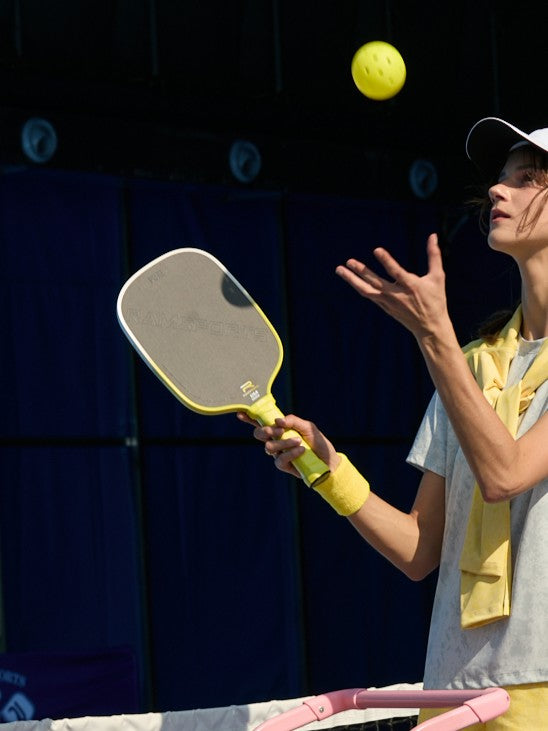 female model playing pickleball using the Ramsports Pure Pickleball Paddle