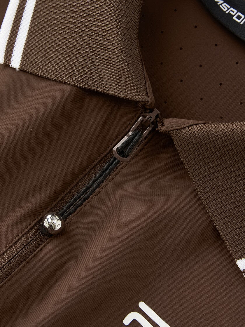 Closer view of Ramsports serve zip crop polo in brown, focusing on the zipper and collar part