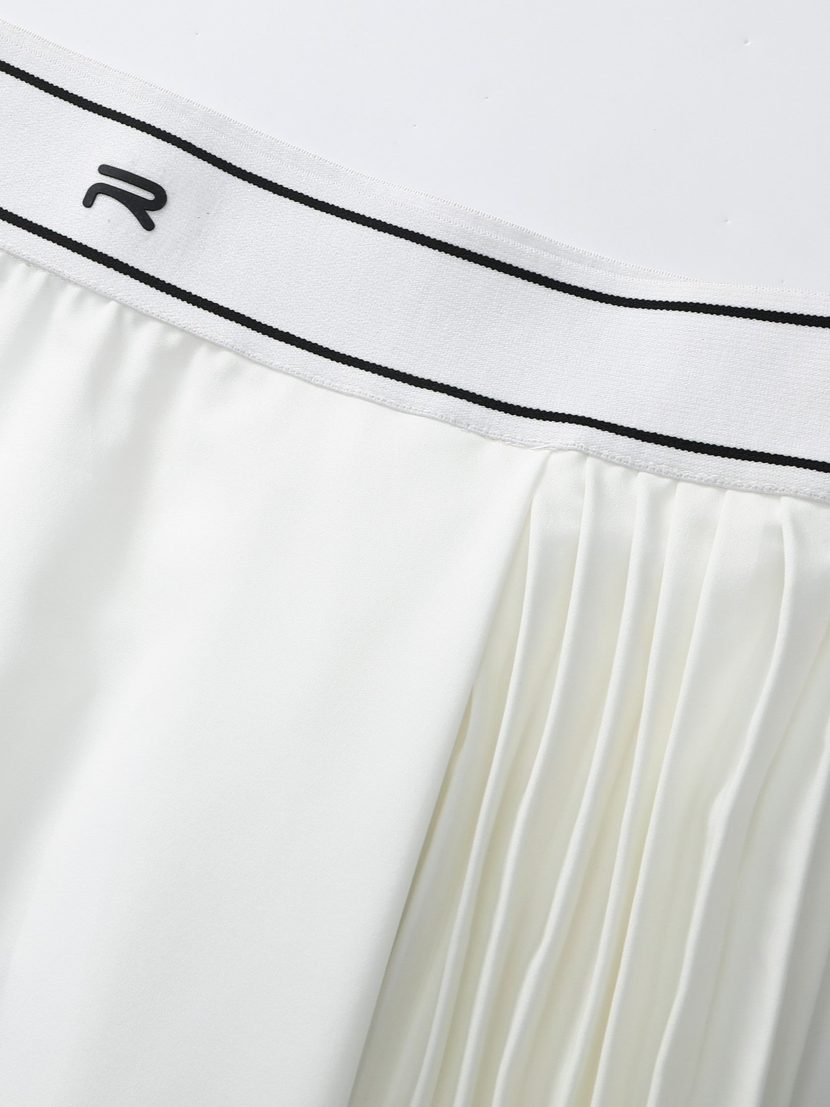 Zoomed-in image showing the logo on the white Ramsports AirFlow Pleated Skort