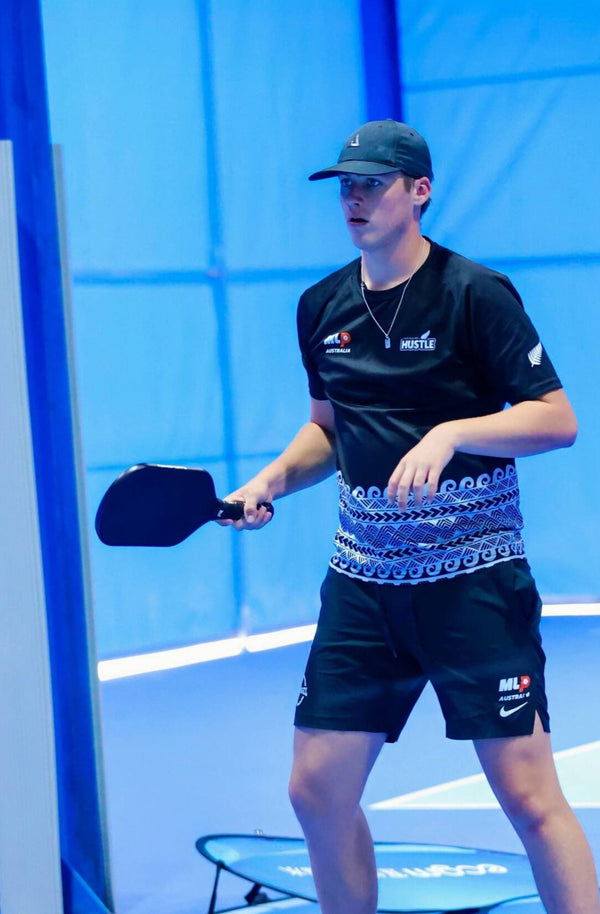 Western male player in action playing pickleball using the Ramsports Ignis Pro Pickleball Paddle