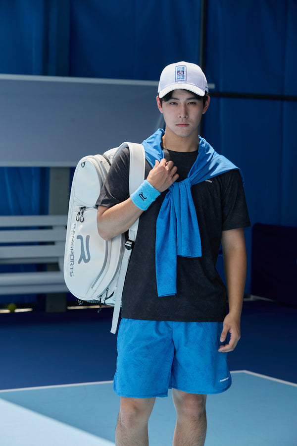 Asian male model wearing the Ramsports LiteCarry Arctic Backpack with one strap, posing in front of the camera