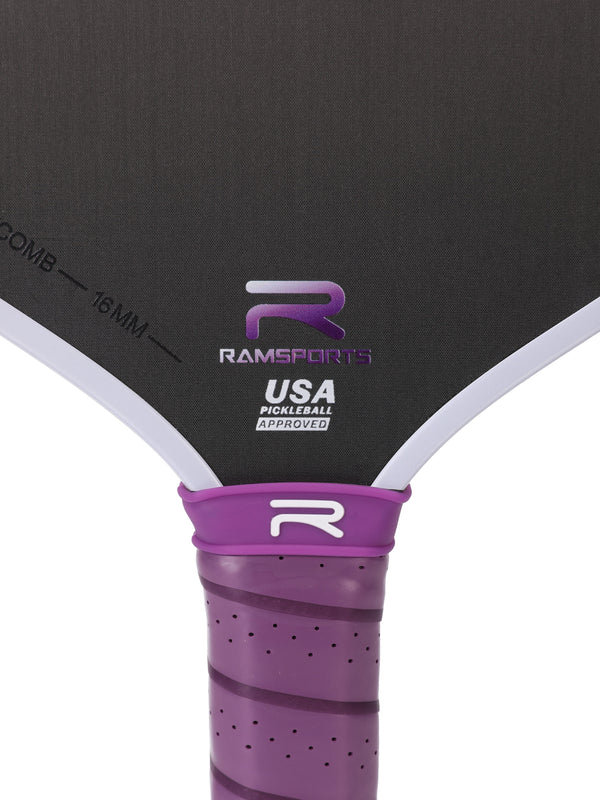Zoomed-in image focusing on the area between the paddle face and handle of the Ramsports Purple Express Pickleball Paddle, highlighting the Ramsports logo