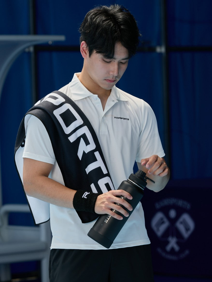 male model in white shirt about to open his Ramsports Black Tumbler