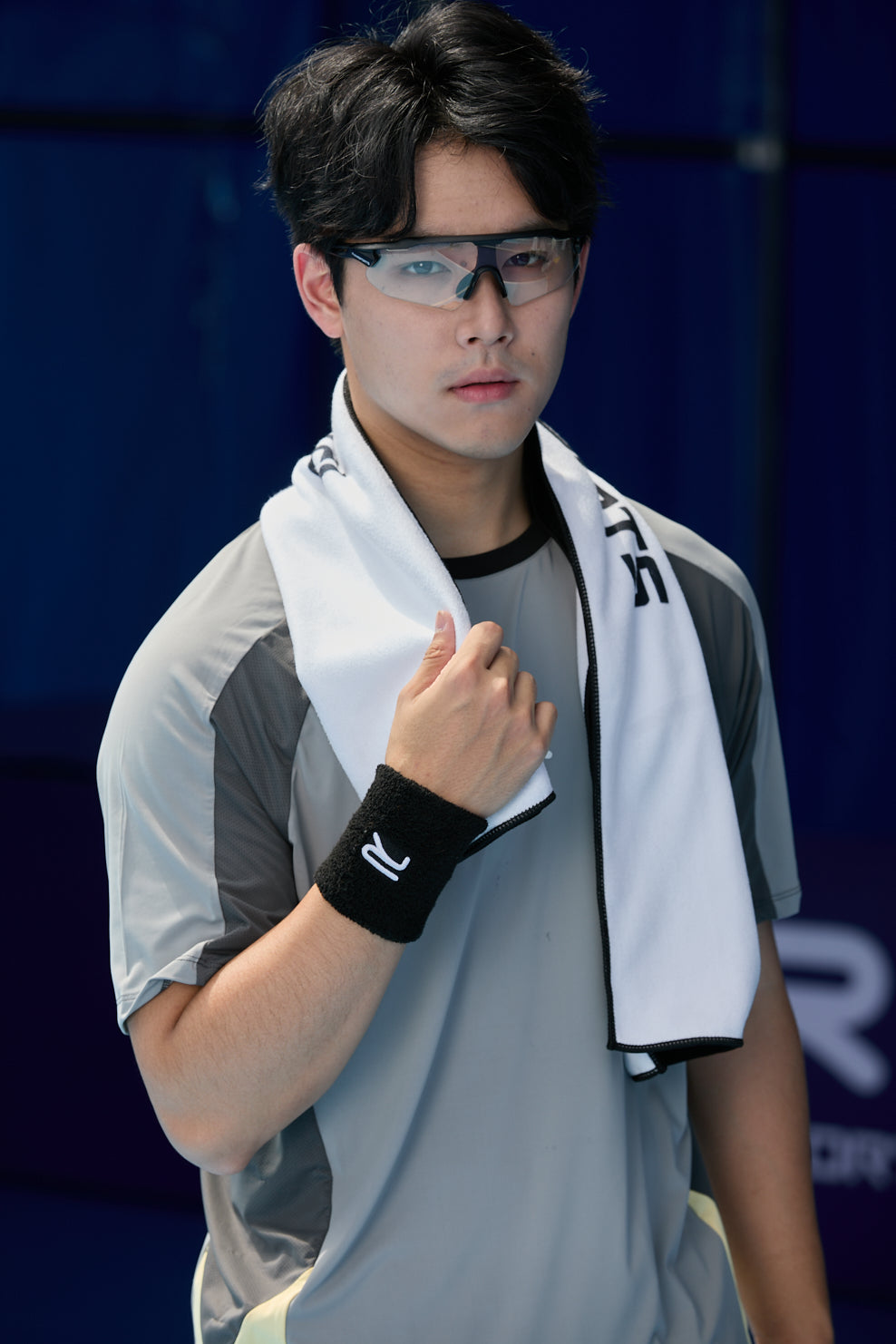 Asian male model with a white Ramsports Pickleball Towel draped around his neck