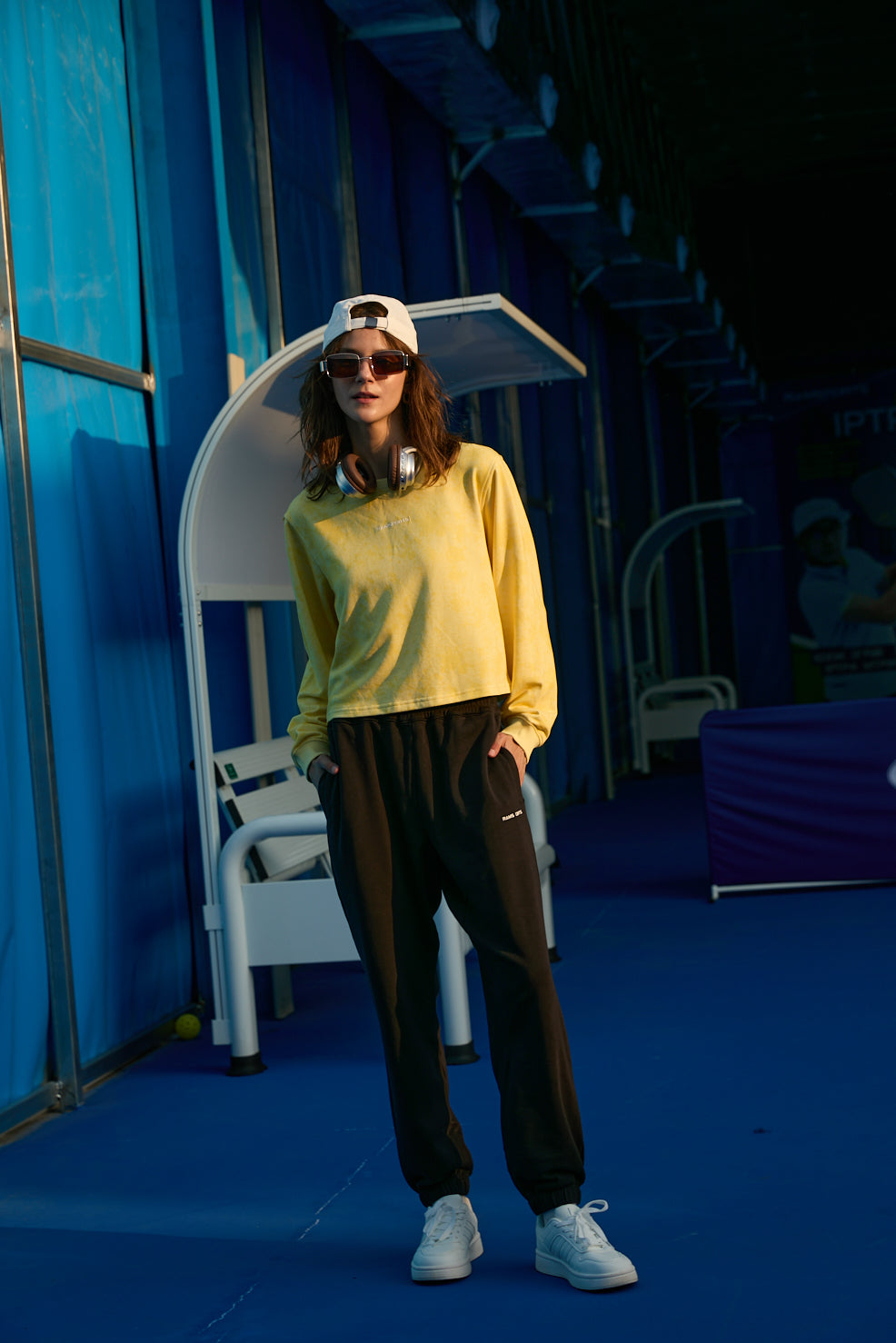 female model posed as her hands were inserted in Ramsports EcoSoft Everyday Jogger in black and yellow longsleeves