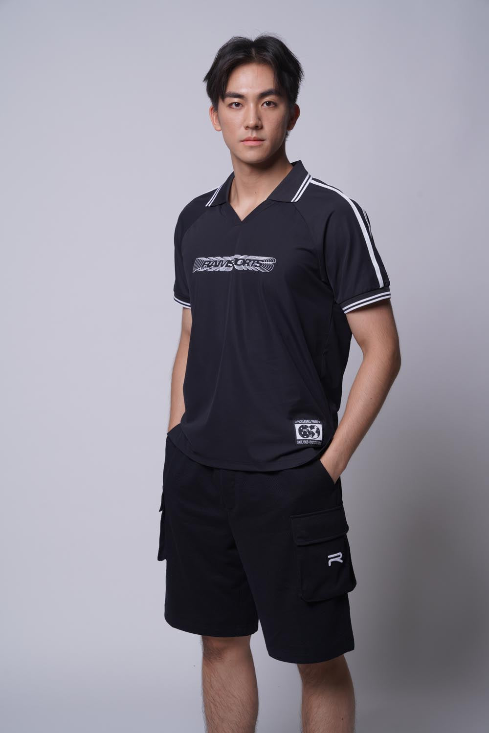 Asian male model with black top wearing Ramsports Court Cargo Utility Short in black