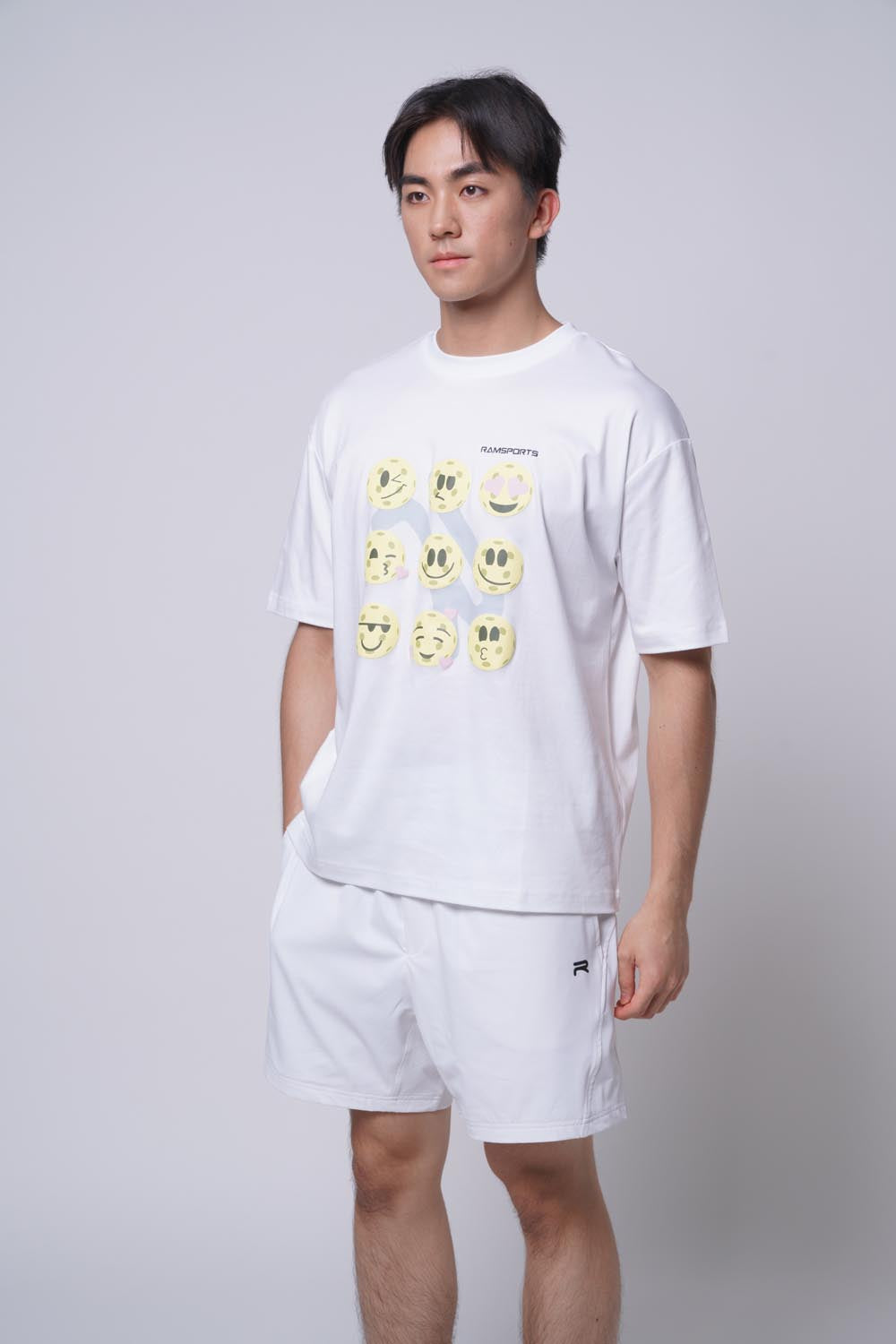 Asian male model standing sideways wearing Ramsports Court Moods Icon Grid T-shirt in white