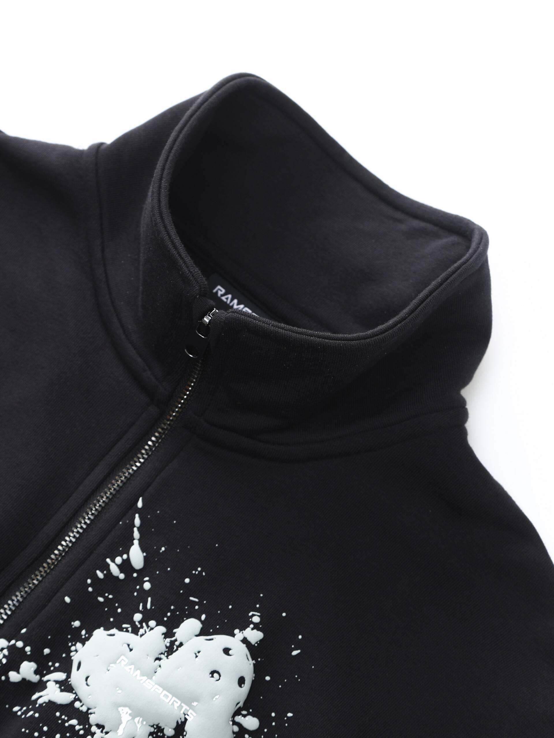 Zoomed-in image of the black Ramsports EcoSoft Half Zip Logo Sweatshirt, focusing on the collar area near the start of the zipper