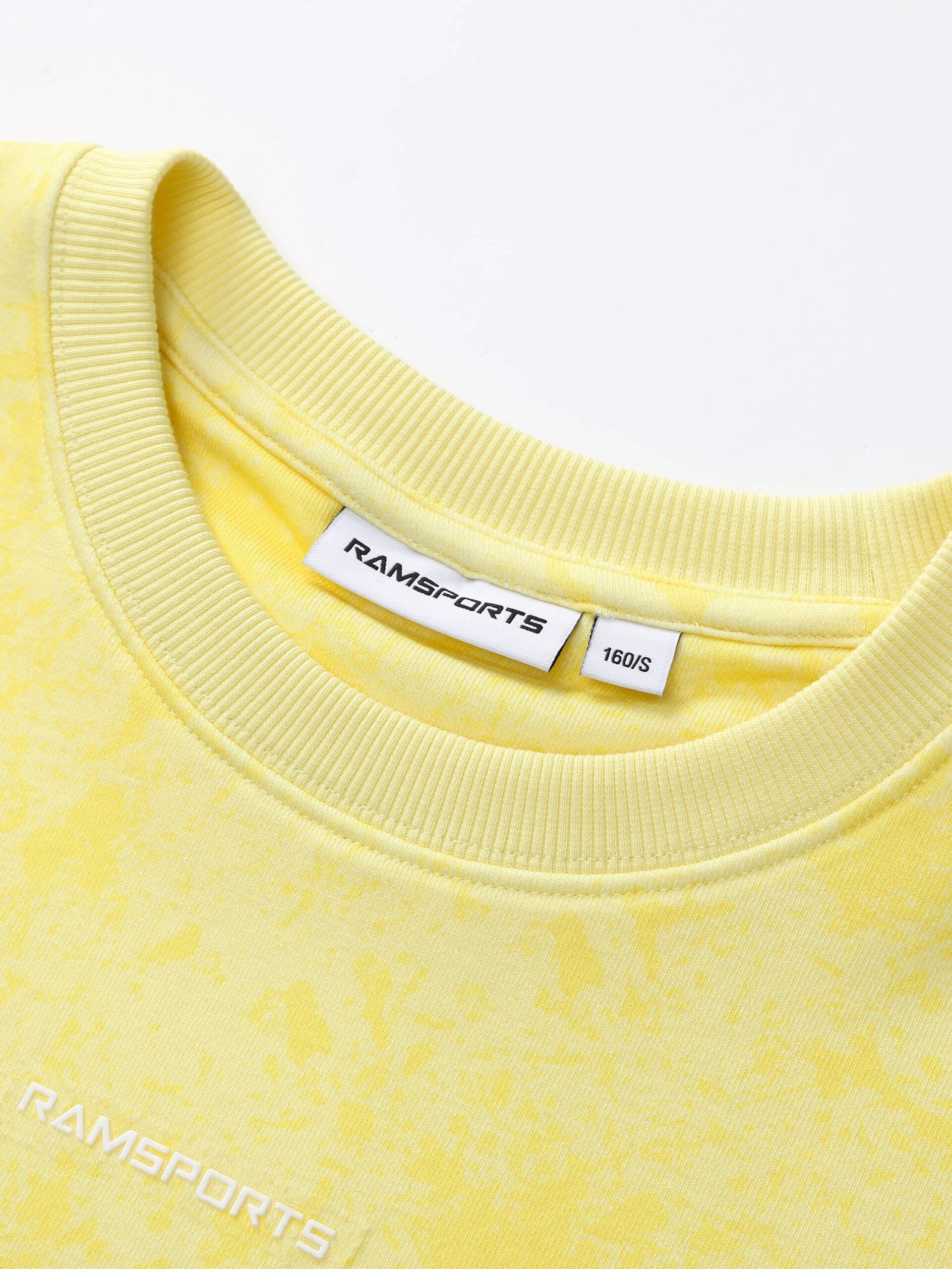Zoomed-in photo of the yellow Ramsports EcoSoft Marble Print Crop Sweatshirt, focusing on the logo tag in the collar.