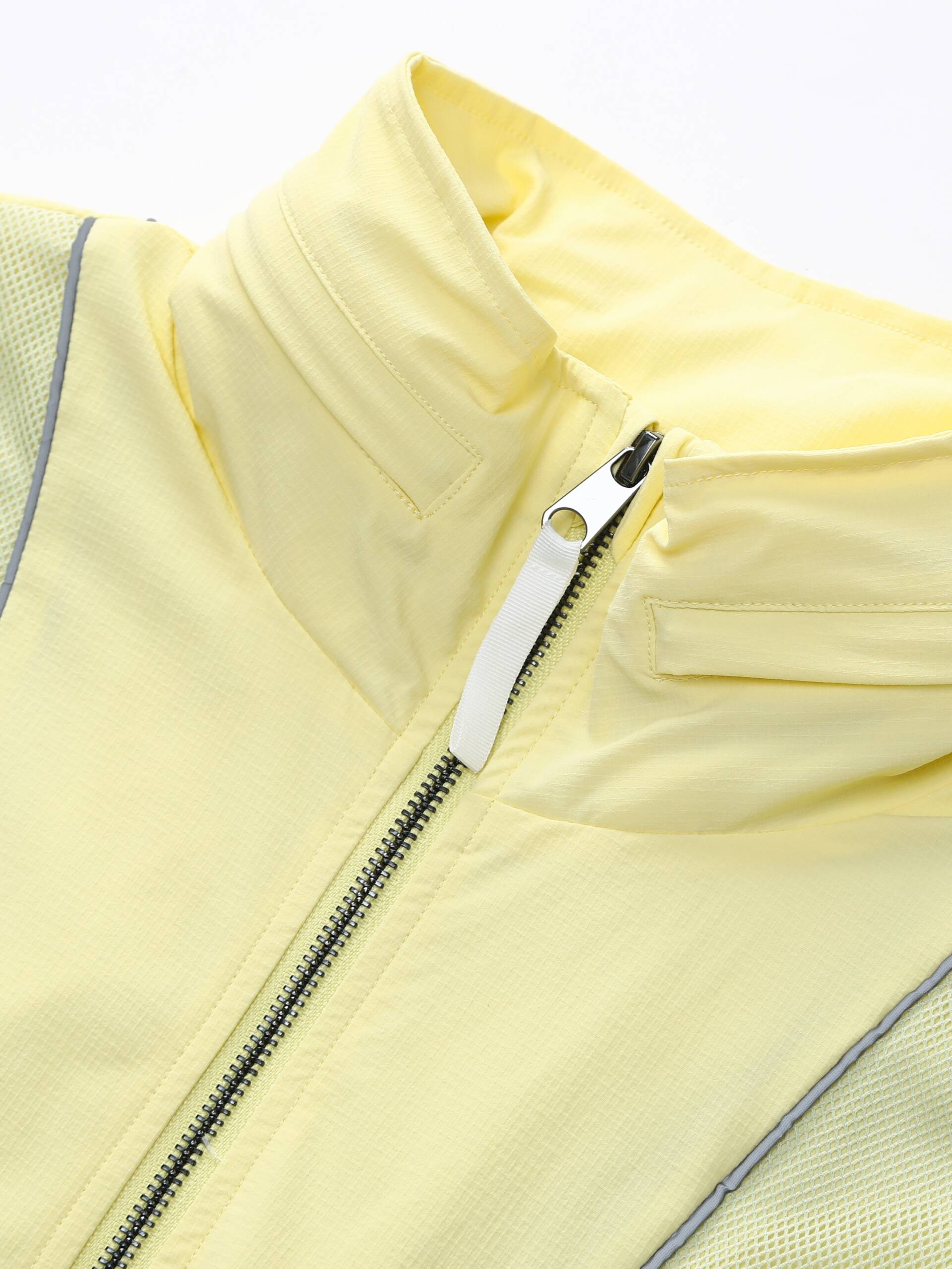 Zoomed-in image showing the zipper detail of the yellow Ramsports FlexTek Block Jacket