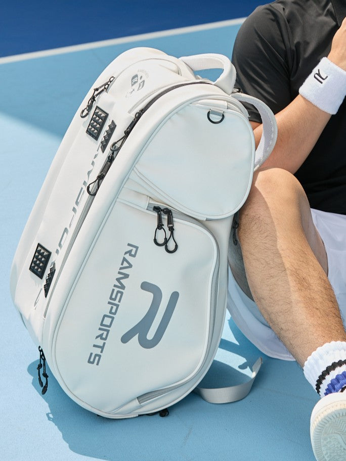 Ramsports Lite Carry Arctic Backpack resting on the ground, leaning against a male model
