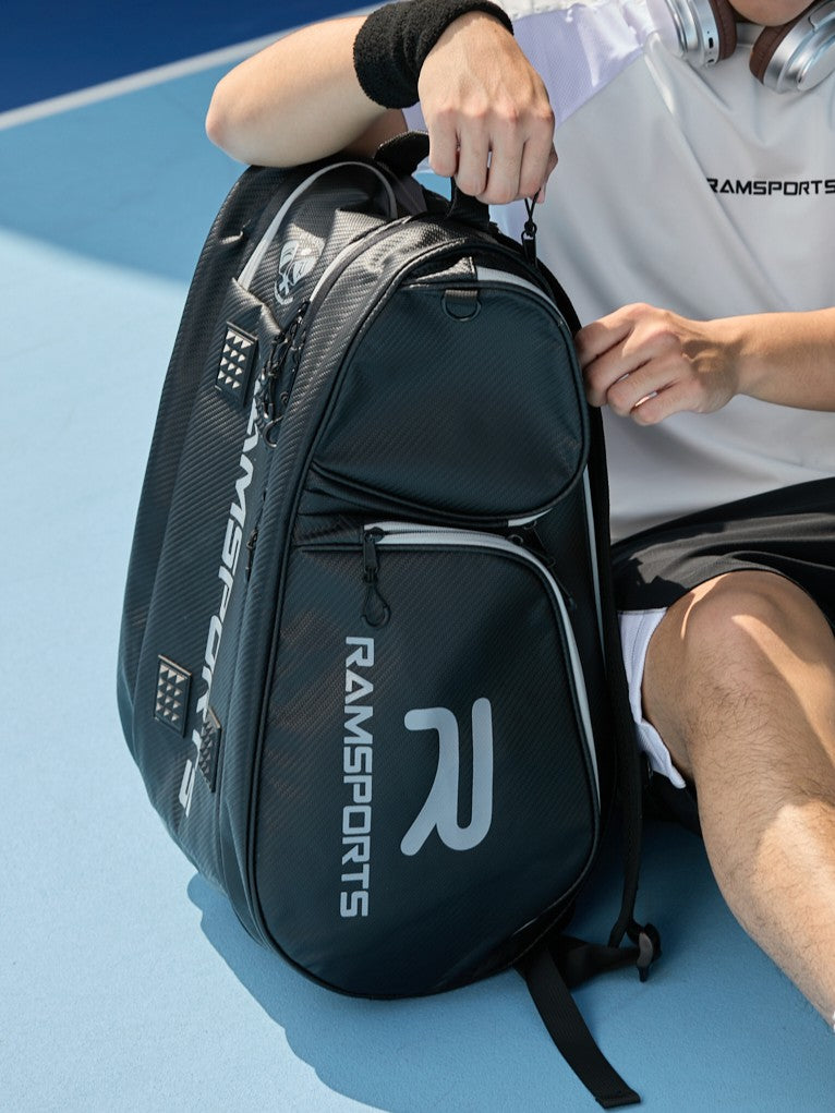 Cropped image of a male model opening the Ramsports LiteCarry Court Backpack placed on the ground